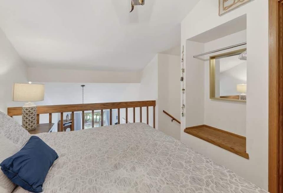 Drift off in this cozy loft bedroom with vaulted ceilings and warm wood accents. Your peaceful retreat features a comfy bed, soft lighting, and thoughtful touches that make it feel like home.