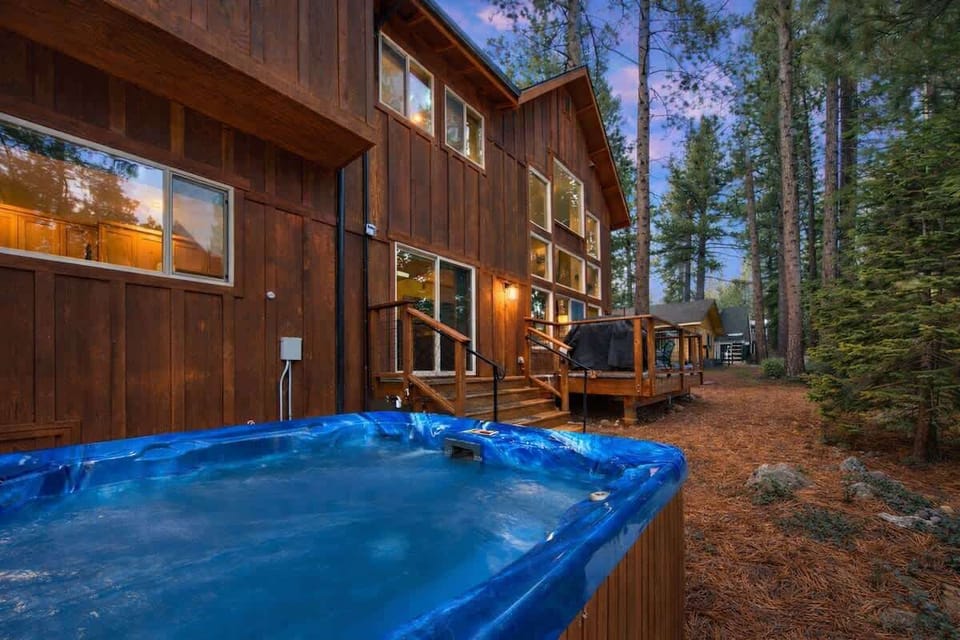 Private hot tub in the backyard of this South Lake Tahoe vacation home, surrounded by pine trees and a spacious deck—perfect for relaxing after skiing, hiking or exploring Lake Tahoe.