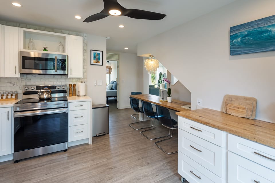 The kitchen opens to the living room on one side, and the patio on the other.