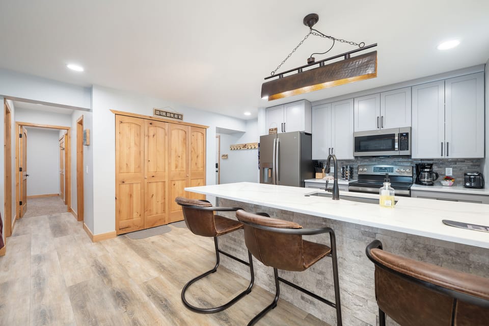 Gather around your spacious kitchen island for morning coffee or evening conversations in this beautifully appointed culinary space.