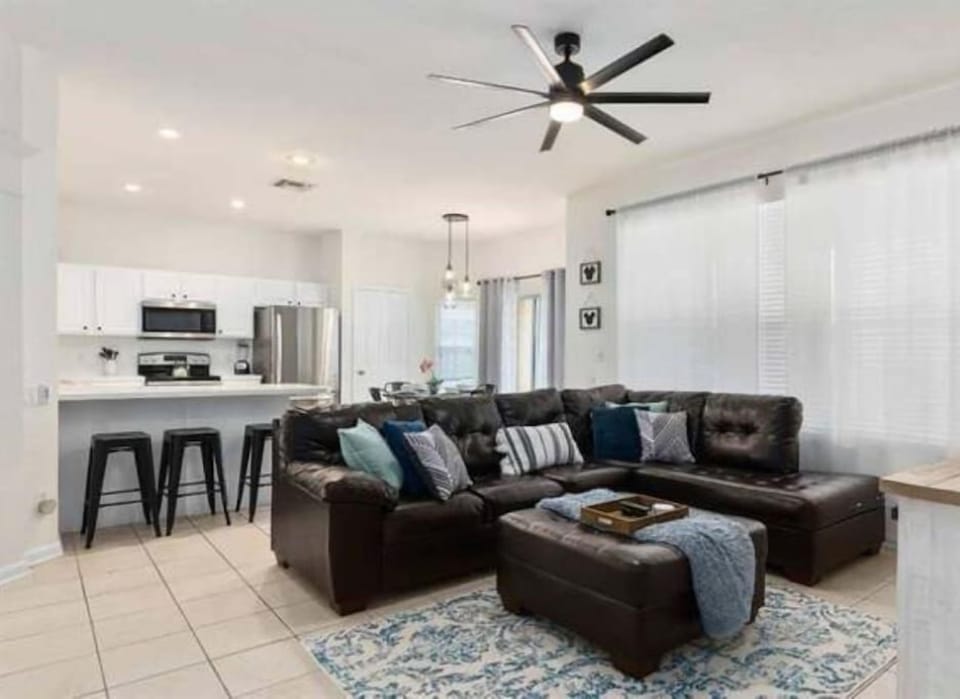 Back living area open to kitchen. View pool and watch 65in TV in comfort of AC