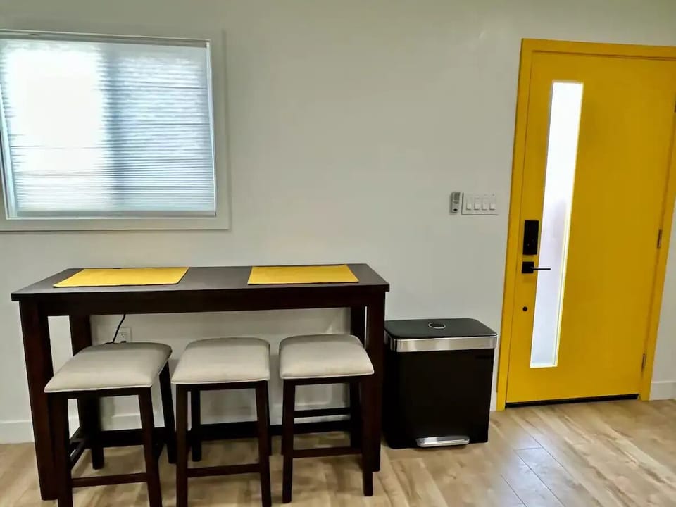 A beautiful wood dinning/working table by the window.