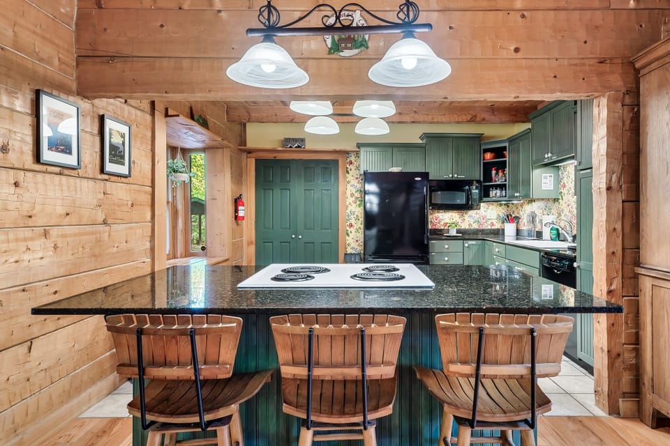 Enjoy cooking and gathering in the kitchen - equipped with an island and bar stools, it is the perfect place to prepare meals for the family and keep restaurant costs to a minimum during your Smoky Mountain vacation!
