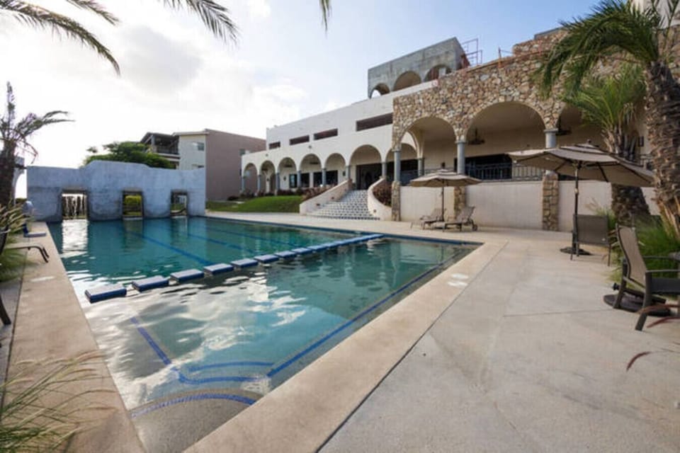 Refreshing community pool surrounded by beautiful Spanish-style architecture.
