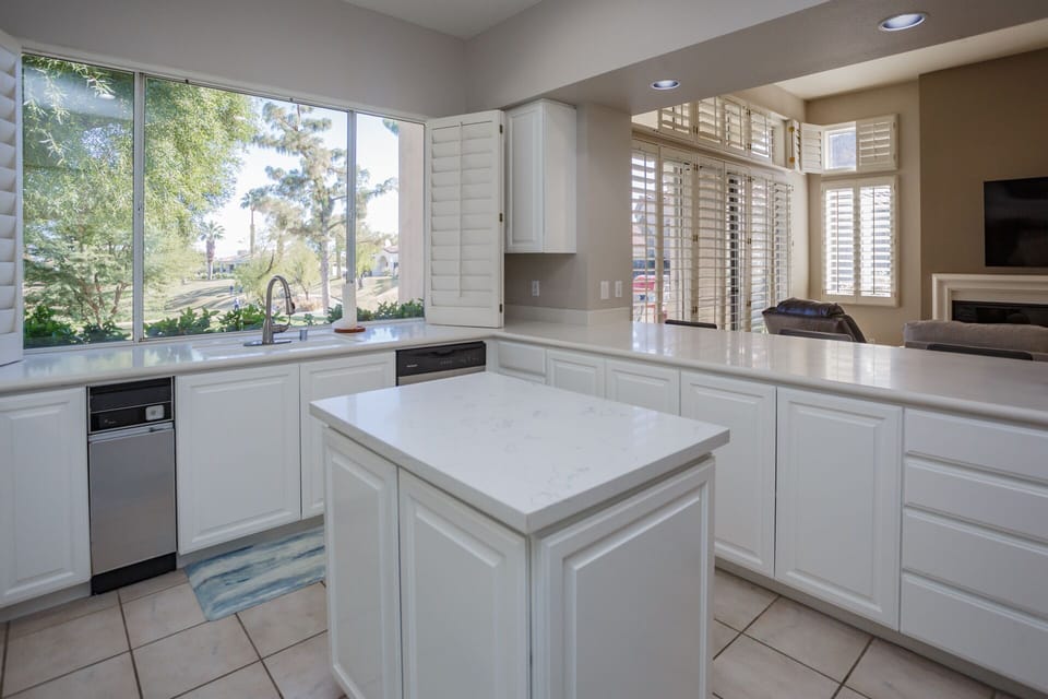 Full kitchen with island and view to golf course.