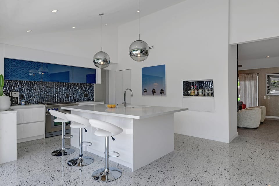 Fully equipped Kitchen with bar seating at center island.