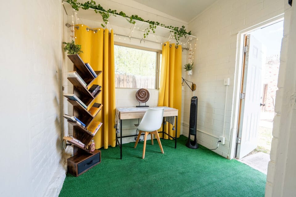 Bright yellow curtains frame this vibrant nook, perfect for inspiration and productivity!