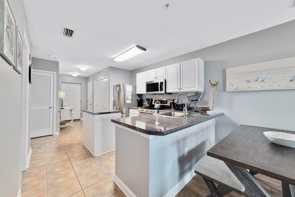 This kitchen offers clean lines and uncluttered surfaces, providing a sleek and efficient space for culinary endeavors while maintaining a modern and understated aesthetic.