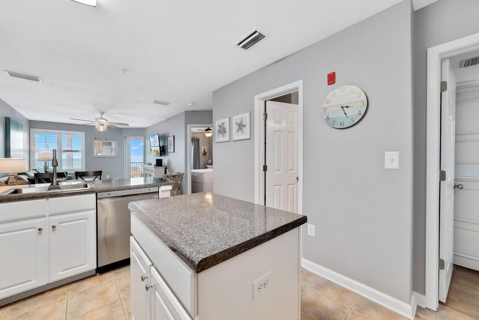 The small island in the kitchen provides extra space for meal prep and storage.