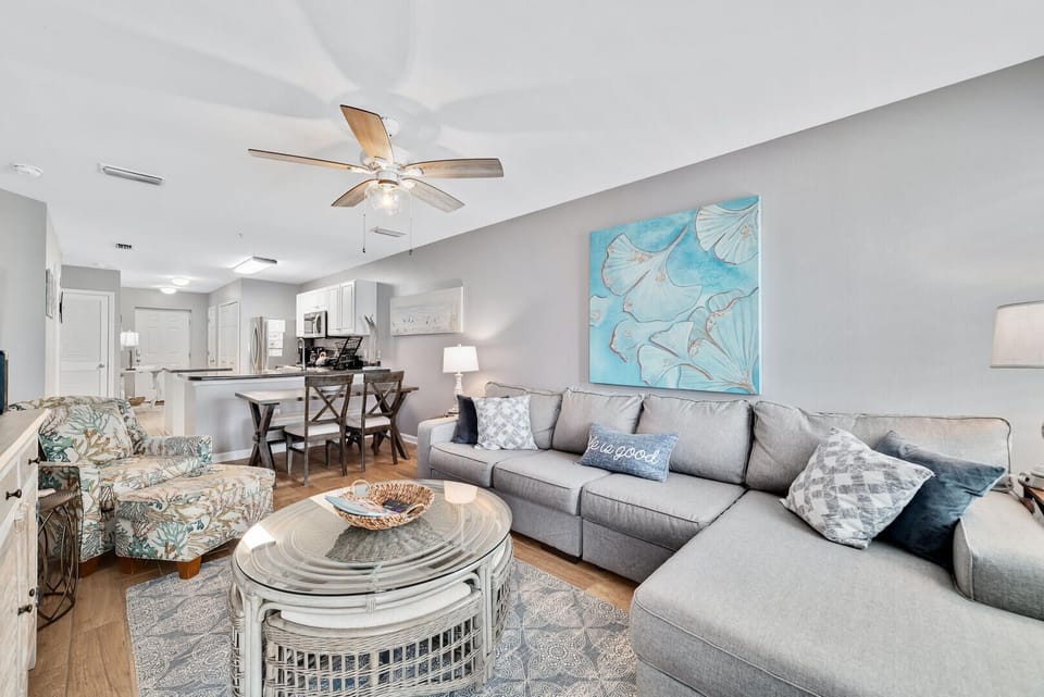 The living room is a coastal retreat offering plush furnishings and inviting decor to encourage relaxation and connection.