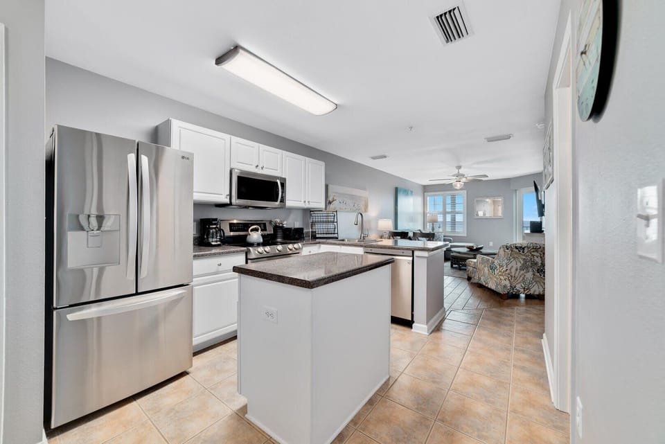 The kitchen is equipped with stainless steel appliances which enhance the luxe aesthetic of the home.