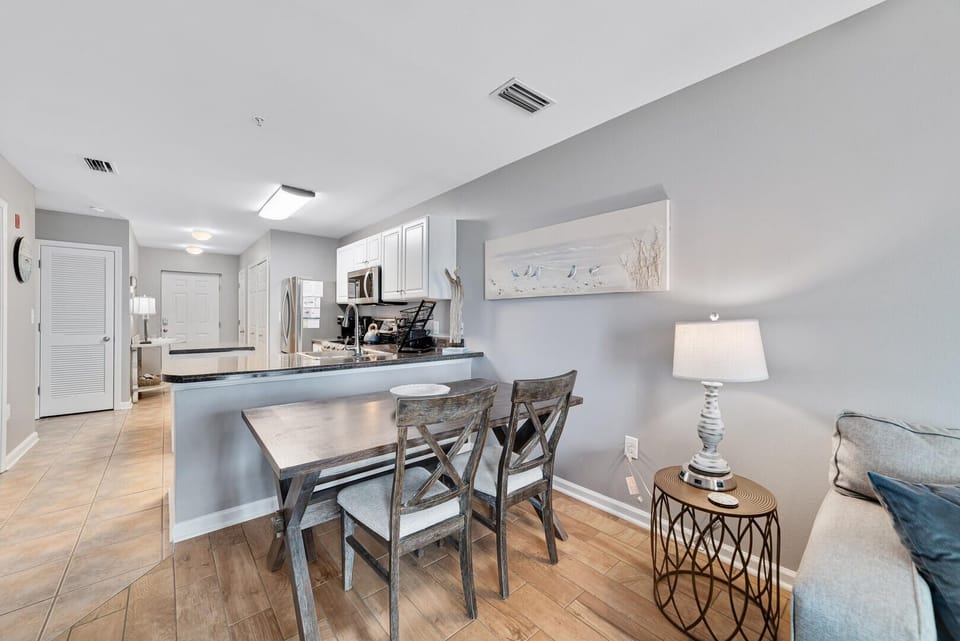 The dining area transitions effortlessly into the kitchen, creating a cohesive space where meals are prepared and shared, fostering togetherness and culinary delight.