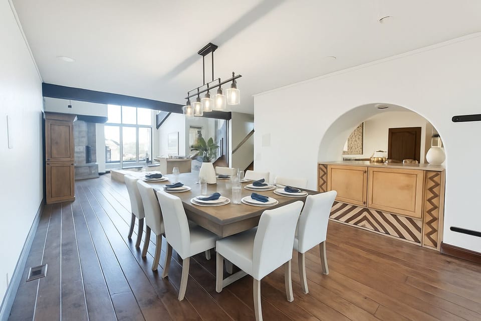 Gather around the elegant dining table where your group can enjoy memorable meals together in this sophisticated space with custom lighting and architectural details.