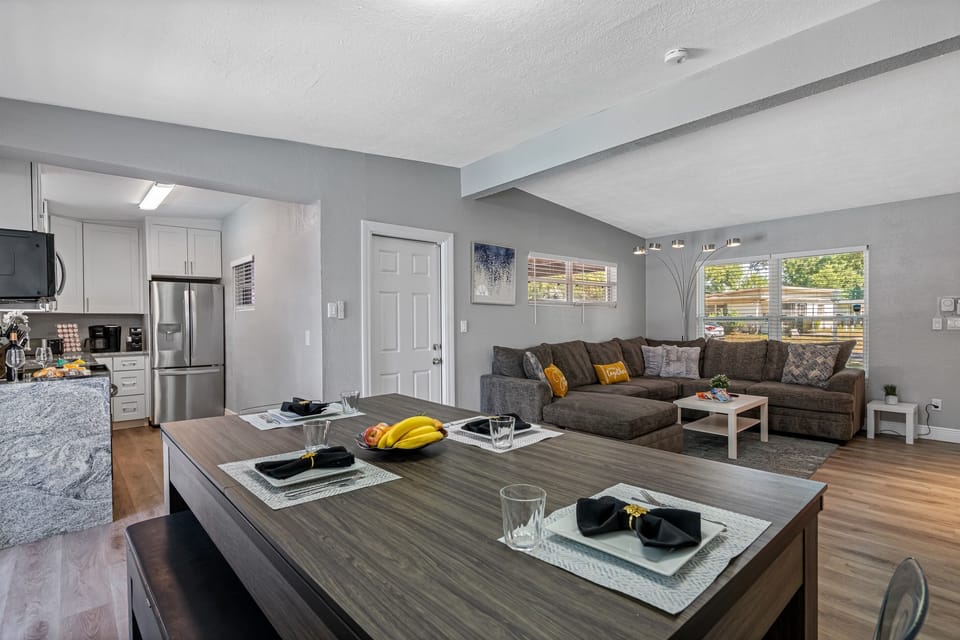 The table's sleek design features a high-quality wood finish that blends seamlessly into any modern interior decor. 