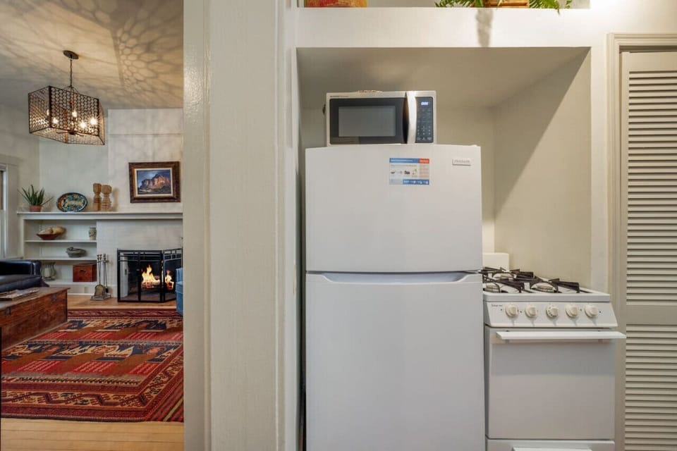 Small but mighty kitchen with fridge/freezer, microwave, stove, and oven