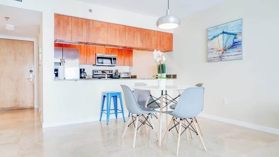 Kitchen with quality appliances, cookware, and cozy 4-seater dining table