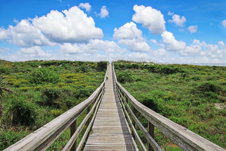 Follow the scenic boardwalk through dunes straight to the sea breeze.
