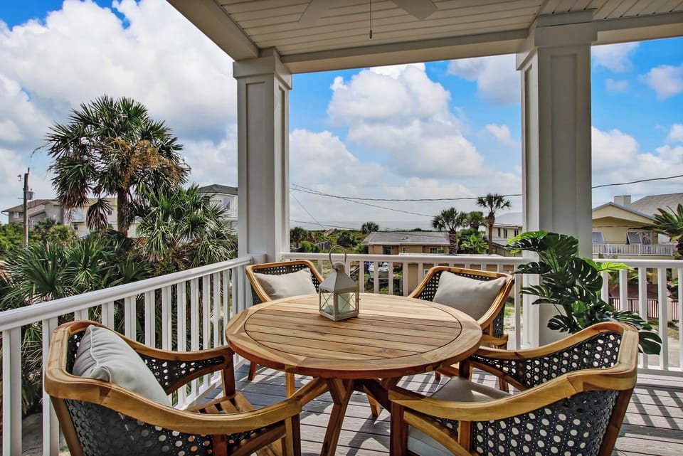 - Soak in the tropical breeze from a private balcony framed by palms & blue skies all around
- Stylish wooden dining set makes outdoor meals & sunset chats truly unforgettable
- Peaceful retreat for morning coffee or evening wine under the coastal air