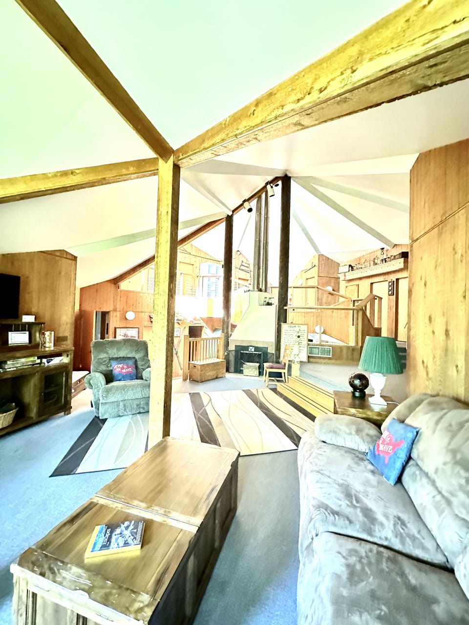 Main living room with wood burning fireplace.