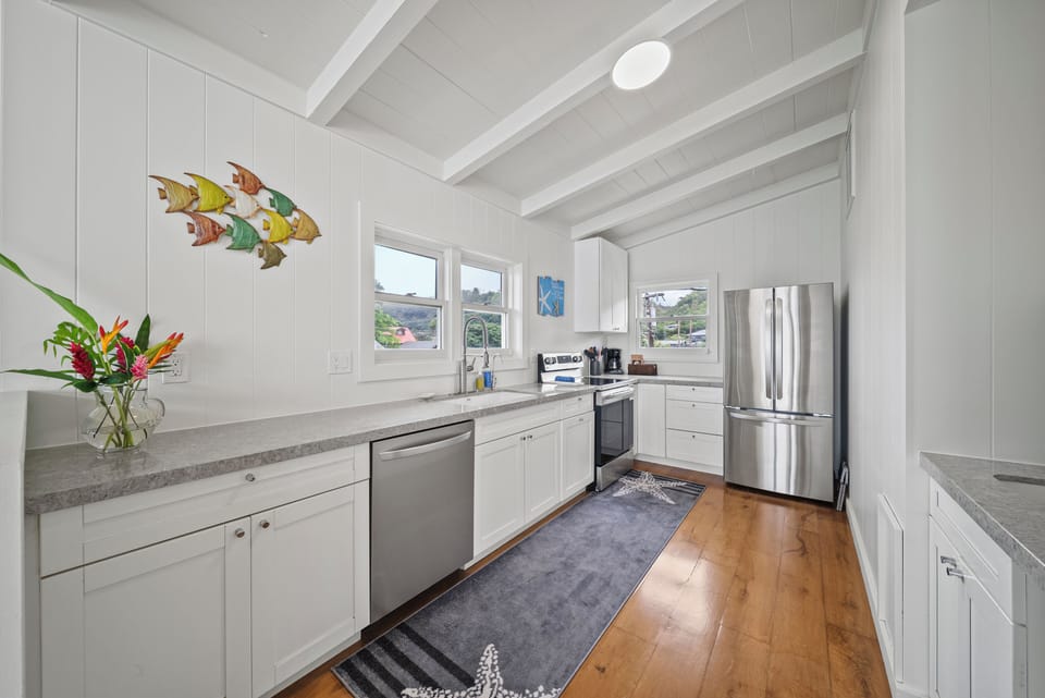 Fully equipped kitchen featuring stainless steel appliances—perfect for preparing island-inspired meals together.