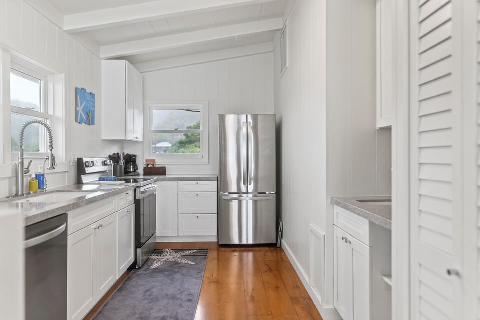 Bright kitchen with sleek stainless steel appliances, perfect for preparing fresh island meals before heading to the beach.
