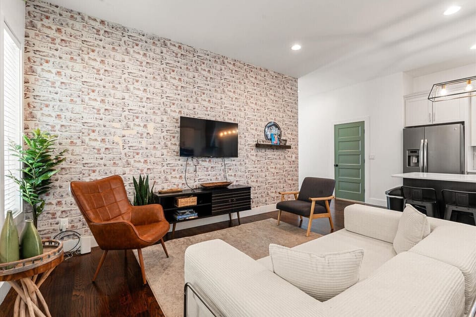 The main living area — SMART TV, plenty of seating, open access to the kitchen and plush King sleeper sofa for extra guests.