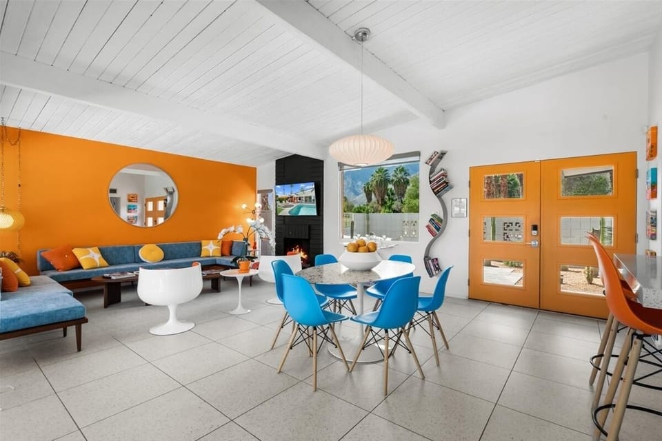 Retro-chic Palm Springs living room w/ pops of orange & stunning mountain views