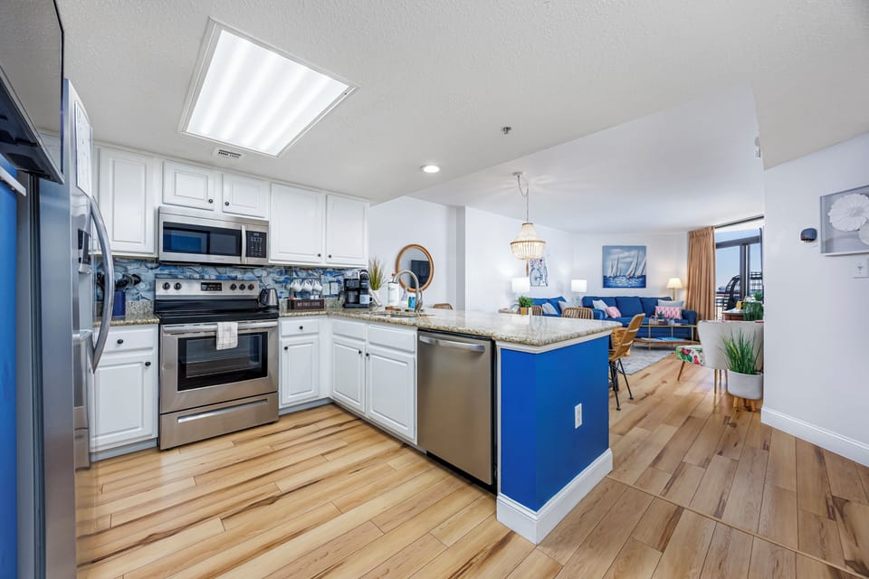Full kitchen with granite countertops, full size appliances & spacious cabinets.