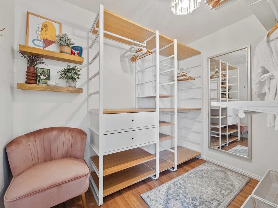 Master walk-in closet with a full length mirror. 