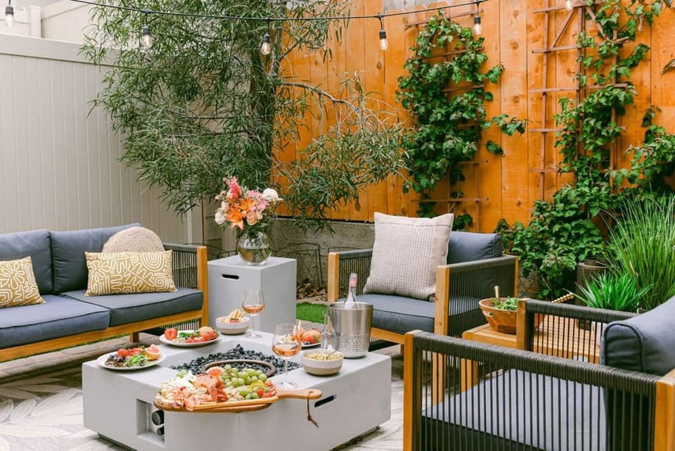 A beautiful fenced in backyard with tall fences, high quality artificial grass, fire pit and plenty of seating.  Perfect for entertaining or a relaxing evening. 