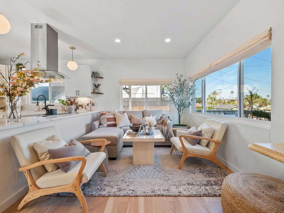 A living room with a comfy sleeper sofa, plenty of seating and a Smart TV.