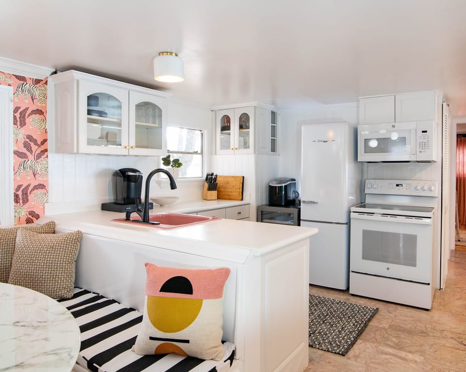 Full kitchen with a stove, oven, refrigerator, microwave, and coffee maker