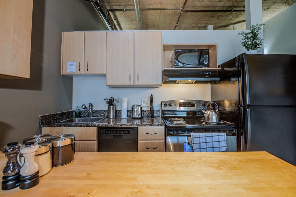 Fully equipped modern kitchen with sleek appliances, ample counter space, and everything you need to cook or entertain