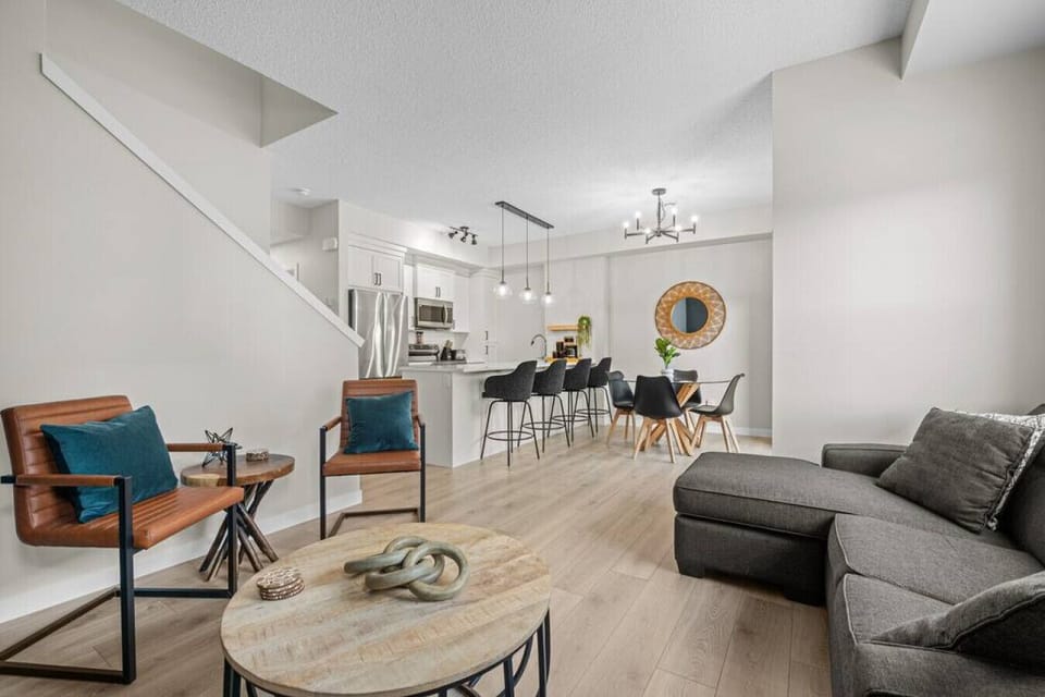 Living room with a Smart TV with cable, cozy seating options and walkout access to the private balcony.