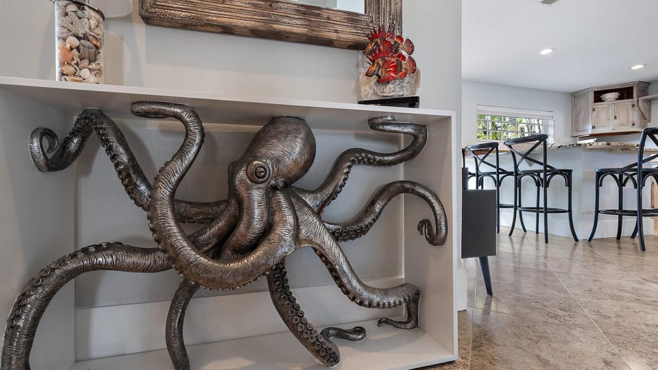 Unique coastal decor with a striking metal modern artistic octopus sculpture.
