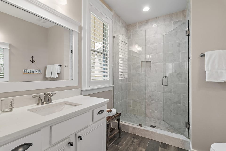 Bright, modern bathroom with spacious glass shower and elegant finishes