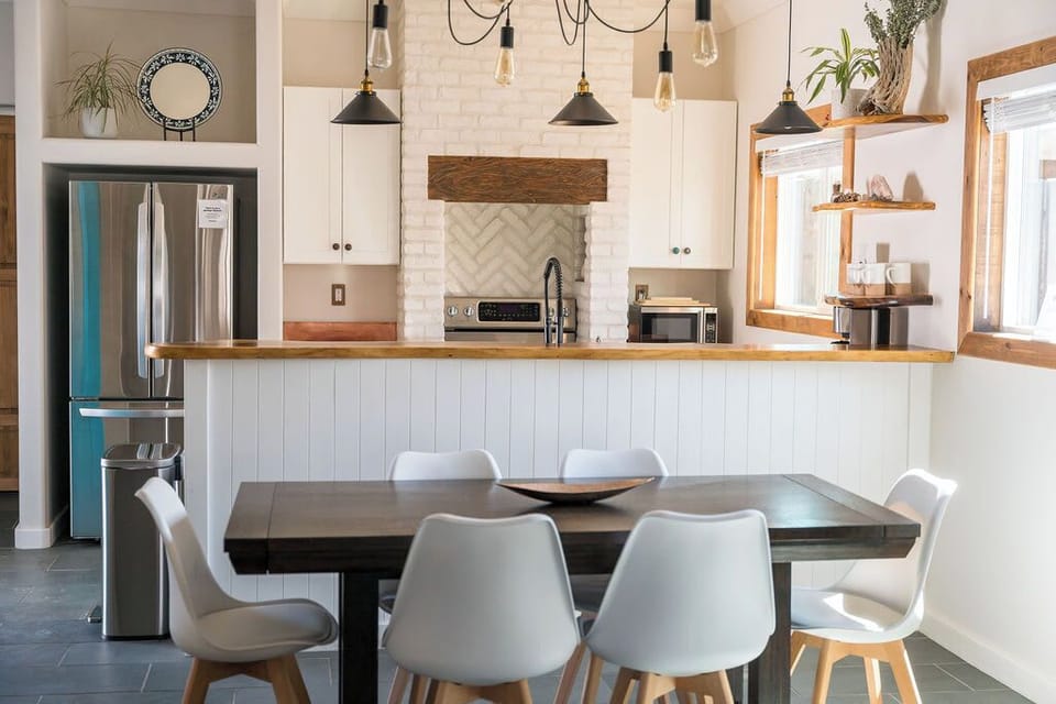A welcoming kitchen overlooking the dining room table.