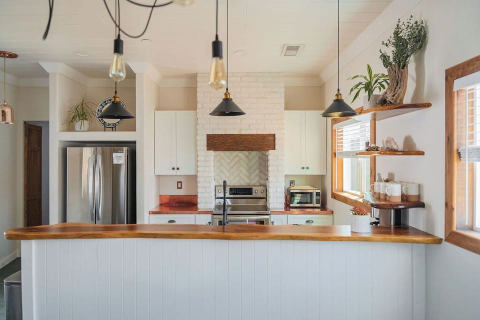 Live wood breakfast bar and pendant lights.