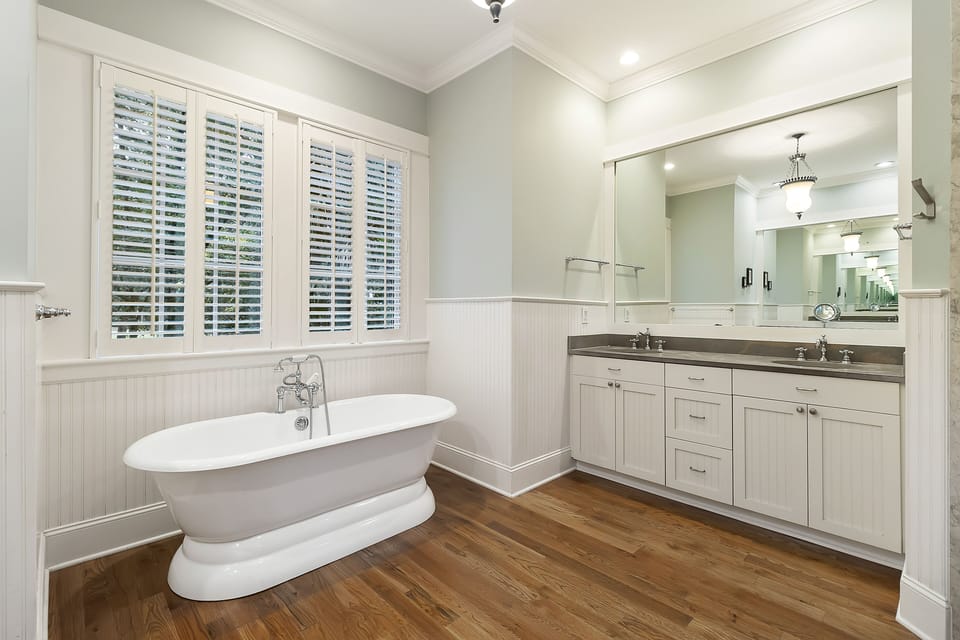 Primary bathroom with soaking tub, dual sinks, standing shower and a separate vanity with seating.