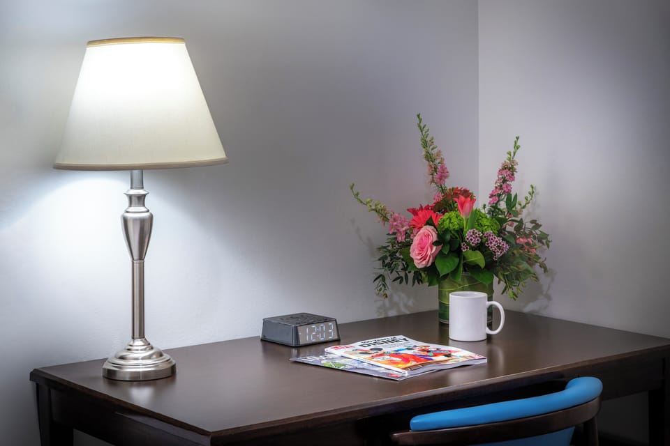 Desk, laptop workspace, iron/ironing board, cribs/infant beds