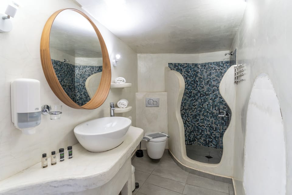 Cave Suite with Caldera & Sea View | Bathroom | Shower, free toiletries, hair dryer, towels