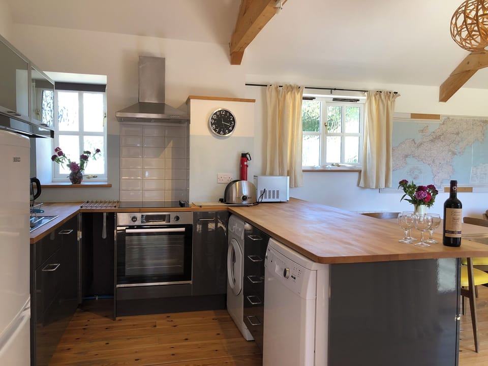 Well equipped kitchen area with integrated oven, hob, washing/dryer machine.