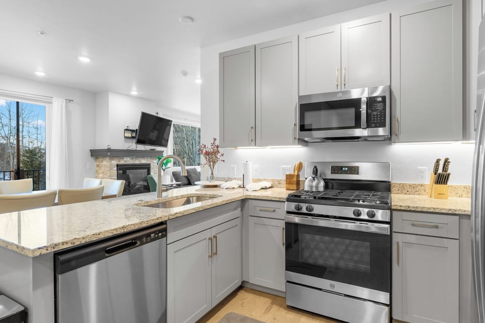 Full-size luxury kitchen with stainless steel appliances and granite countertops.