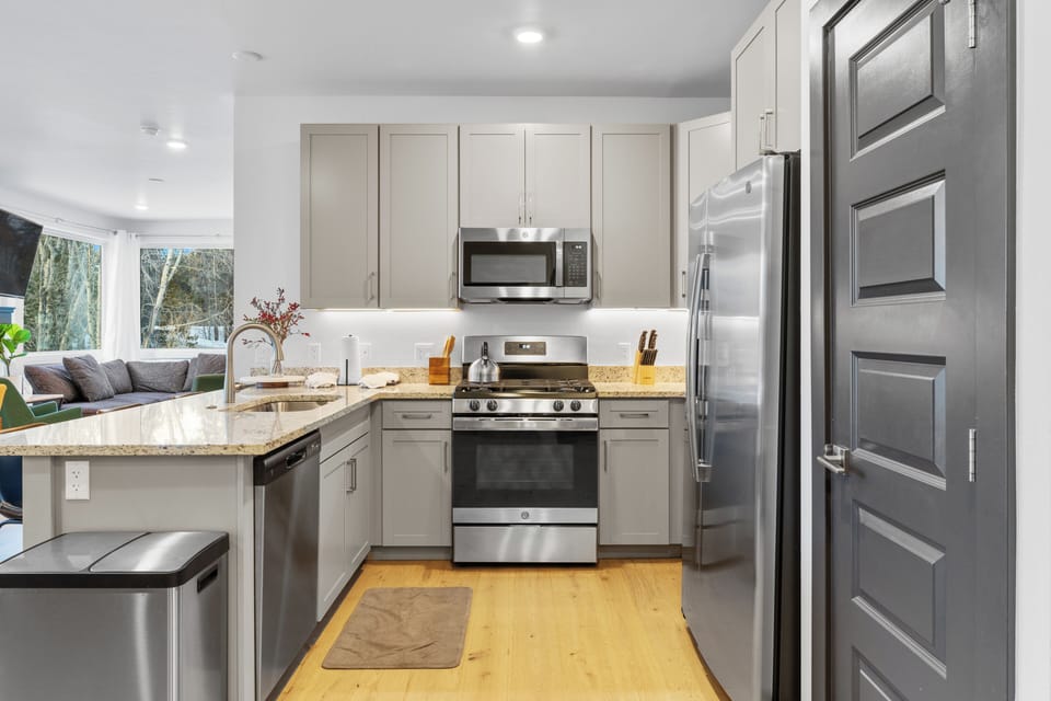 Full-size luxury kitchen with stainless steel appliances and granite countertops.