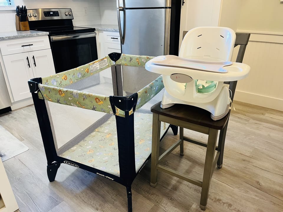Pack 'n play and highchair for your use! Just bring your own crib sheet