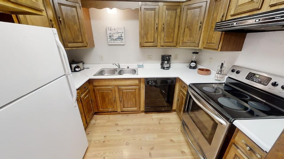 Your fully equipped kitchen features warm wood cabinetry, modern appliances, and all the essentials for preparing your favorite meals during your stay.