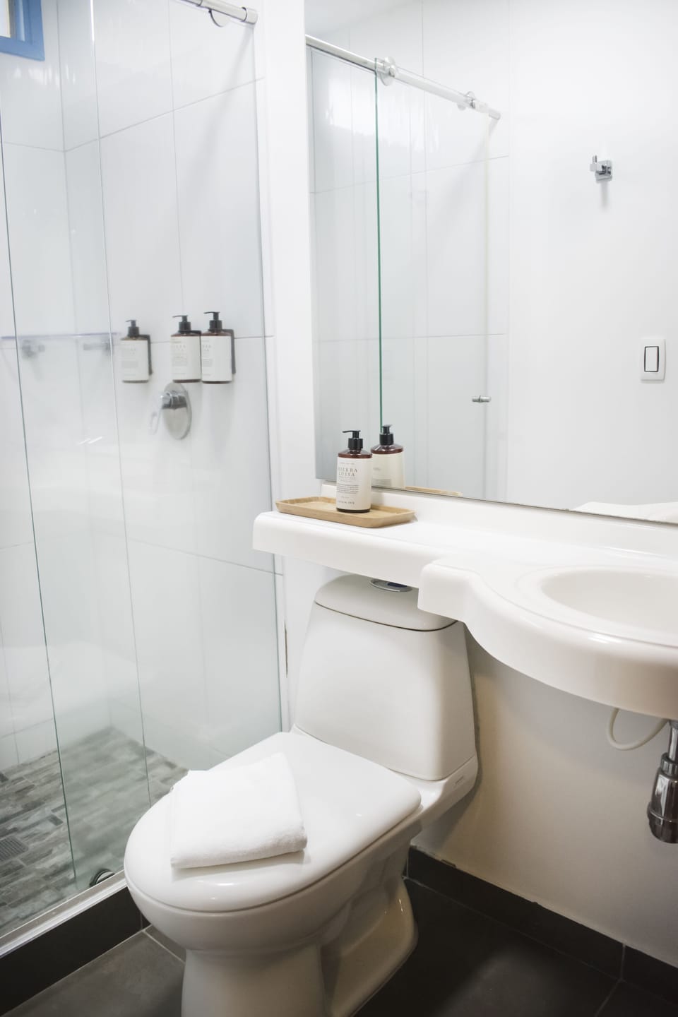 Shower, rainfall showerhead, hair dryer, towels
