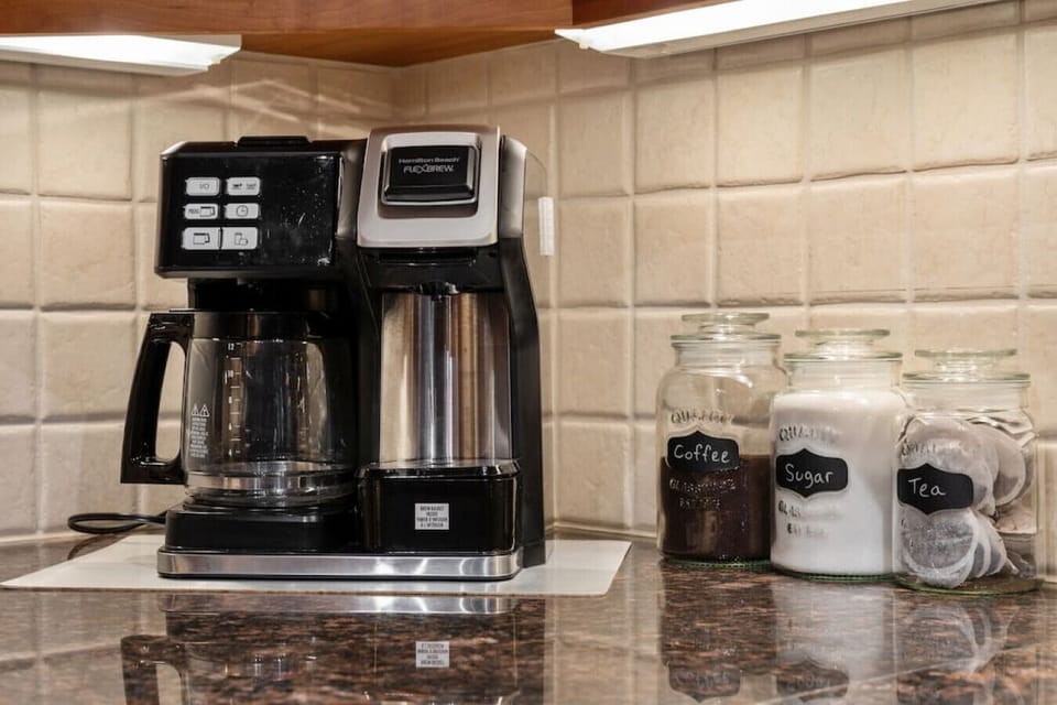 Kitchen includes a coffee maker, ground coffee, sugar & tea.