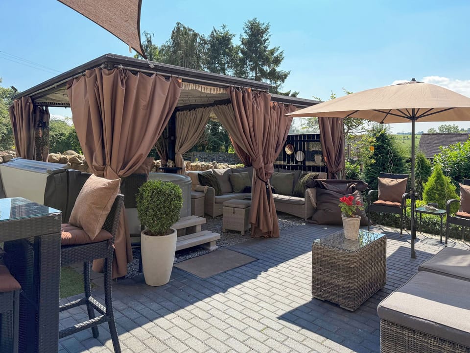 Sun trap living area - al-fresco dining and hot tub | Cherry Cottage, Little Salkeld, near Penrith