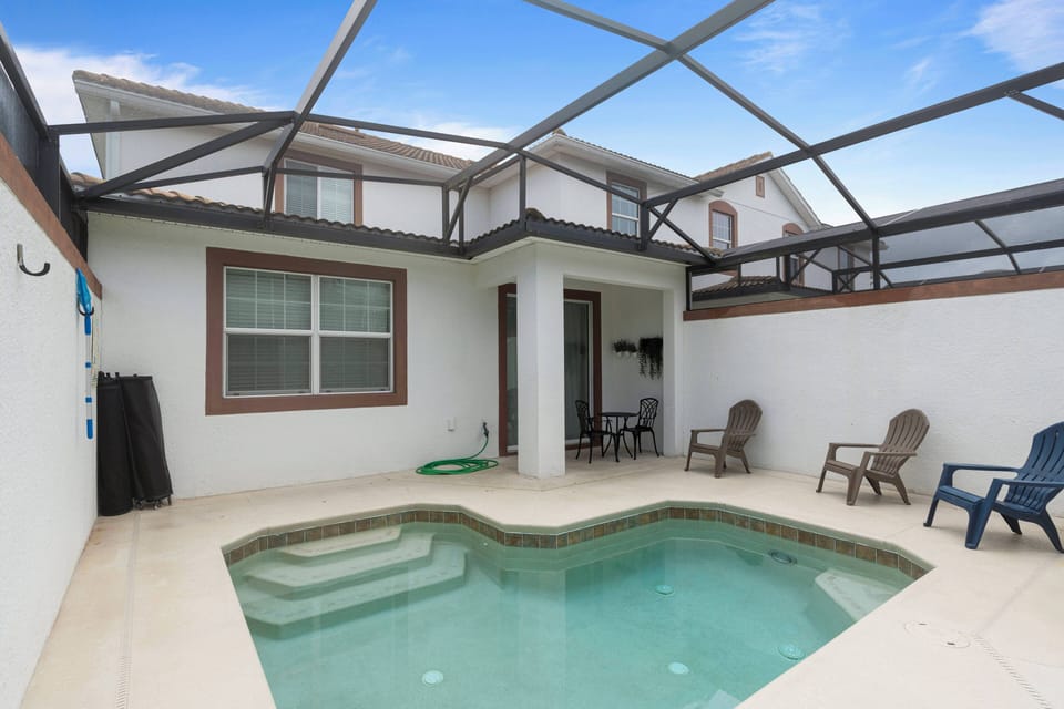 Discover your private oasis with a sparkling pool, surrounded by sleek tile and cozy seating. Bathed in natural light, this inviting space is perfect for relaxation after a day of adventure. Enjoy your time here!